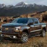 A black 2020 Chevy Silverado is parked in a field after leaving a used Chevy Silverado 1500 dealer.