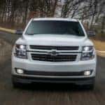 A white 2018 Chevy Tahoe RST is shown from teh front after driving around a corner.