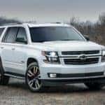 A white 2019 Chevy Tahoe RST is shown parked on a gravel path.