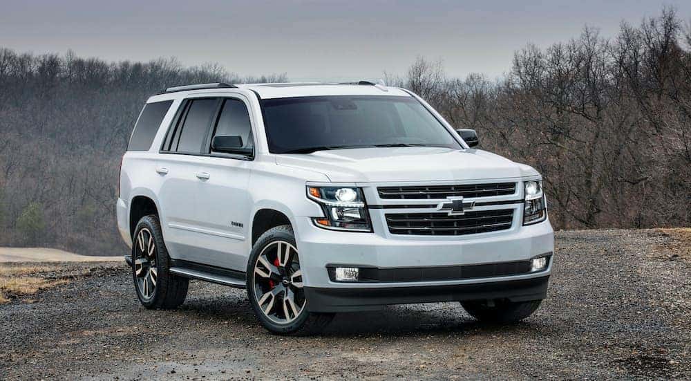 A white 2019 Chevy Tahoe RST is shown parked on a gravel path.