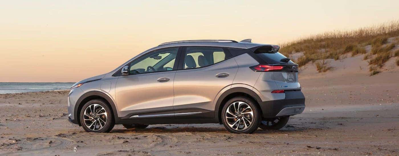 A silver 2022 Chevy Bolt EUV is shown from the side parked on a beach.