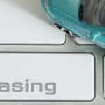 A keyboard shows a leasing button next to a toy car.