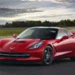 A red 2014 Chevy Corvette is shown at a racetrack after visiting an Atlanta Certified Pre-Owned Chevy dealer.