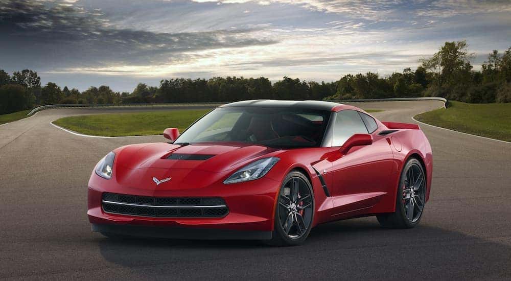 A red 2014 Chevy Corvette is shown at a racetrack after visiting an Atlanta Certified Pre-Owned Chevy dealer.