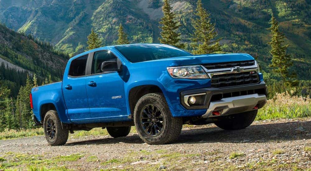 A blue 2022 Chevy Colorado Z71 is shown on a dirt trail after leaving a Suwanee Chevy dealership.