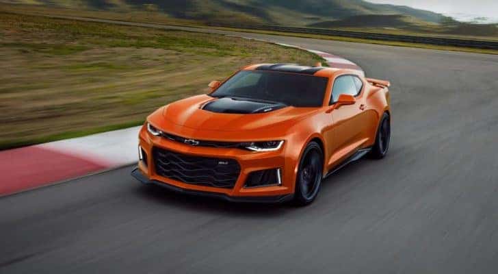 An orange 2022 Chevy Camaro Z71 is shown leaving a Lawrenceville Chevrolet dealer.
