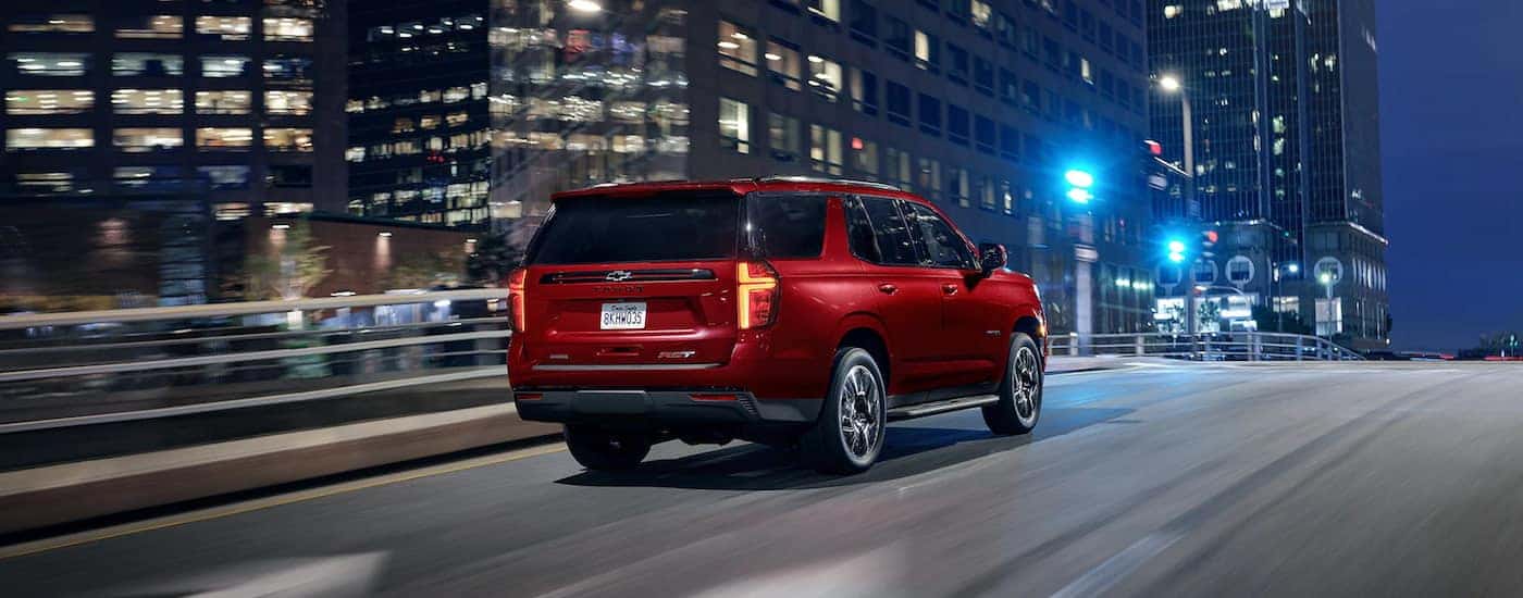 A red 2022 Chevy Tahoe RST is shown from the rear after leaving a Lawrenceville Chevrolet dealer.