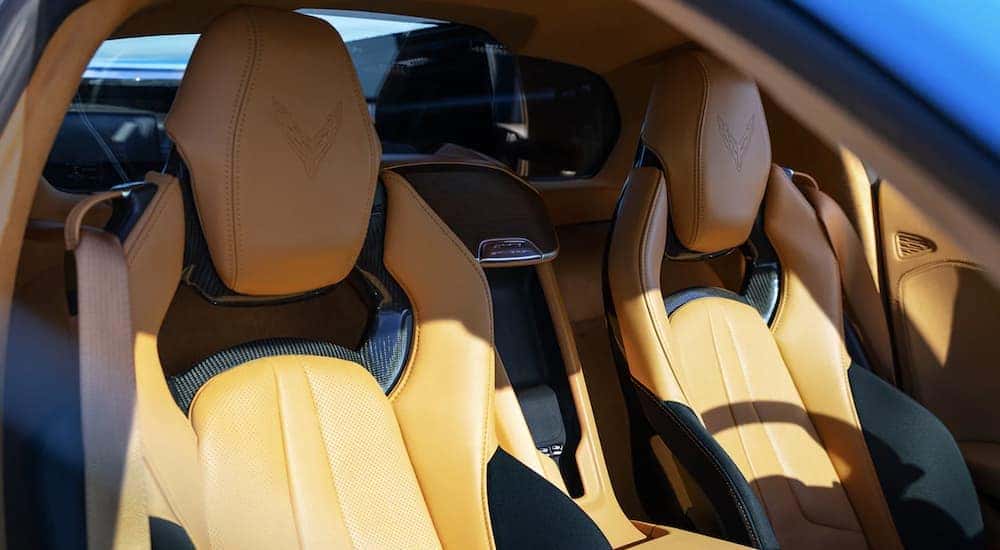 The yellow and black interior of a 2021 Chevy Corvette shows the front seats.