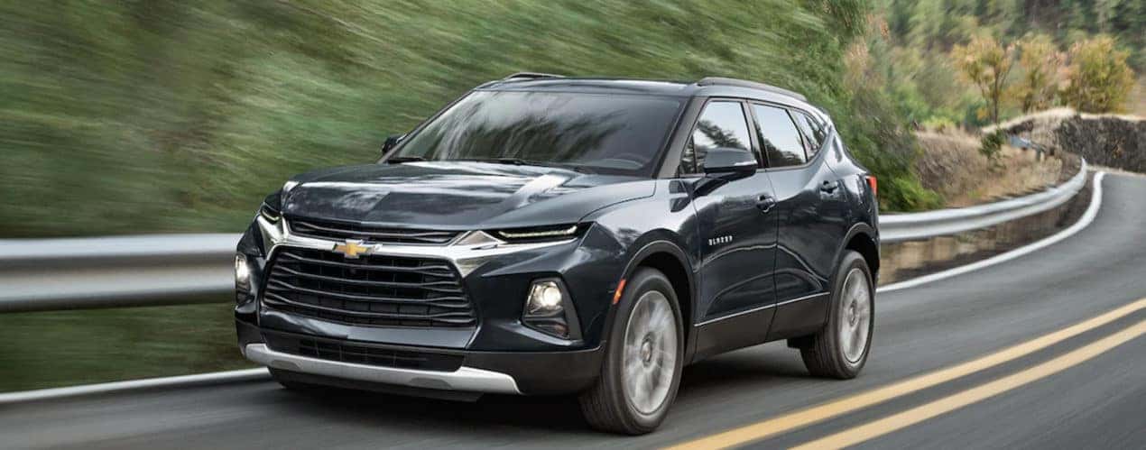 A black 2022 Chevy Blazer is shown from the front driving on an open road.