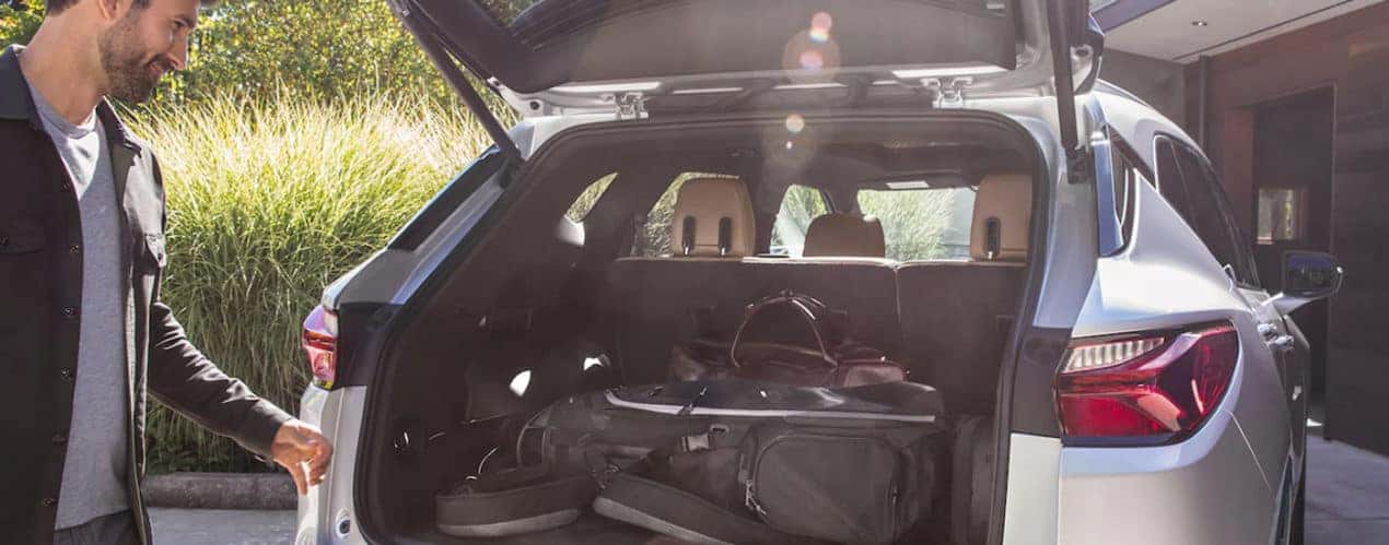 A person is shown loading the cargo area of a 2022 Chevy Blazer during a 2022 Chevy Blazer vs 2022 Honda Passport comparison.