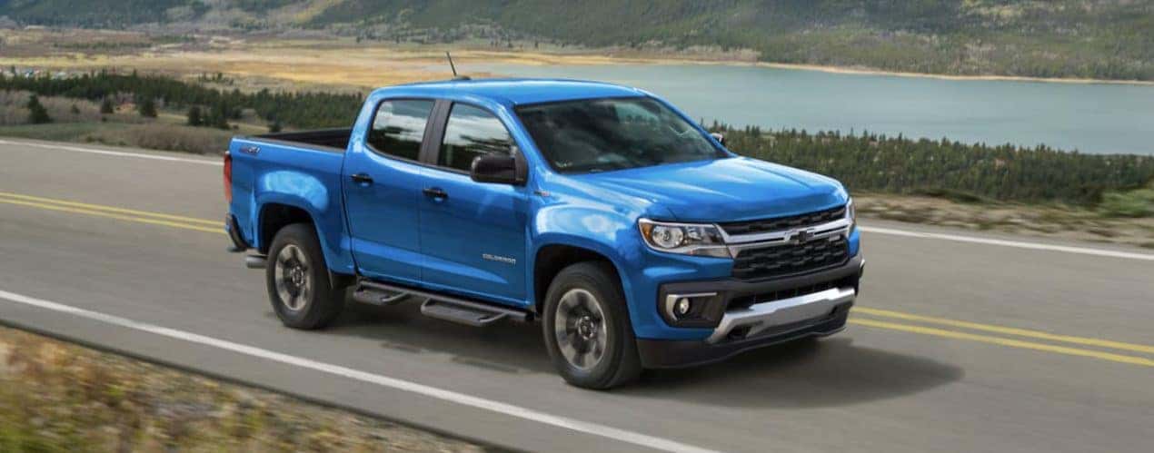 A blue 2022 Chevy Colorado Z71 is shown from the side driving on an open road.