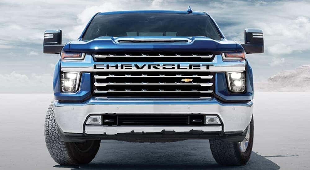 A popular Chevy Silverado 2500 HD for sale, a blue 2023 Chevy Silverado 2500 HD is shown from the front parked on a salt flat.