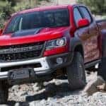 A red 2019 Chevy Colorado ZR2 Bison is shown off-roading.