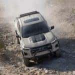 A tan 2023 Chevy Colorado ZR2 is shown off-roading.