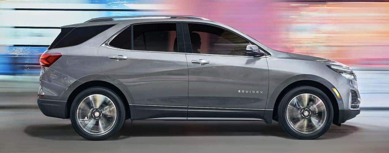 A grey 2023 Chevy Equinox is shown from the side during a 2023 Chevy Equinox vs 2023 Nissan Rogue comparison.