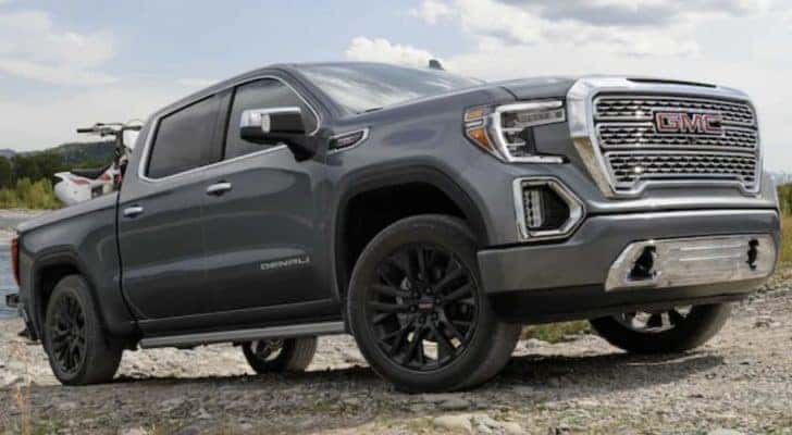 A grey 2021 GMC Sierra 1500 Denali is shown from the side off-roading.
