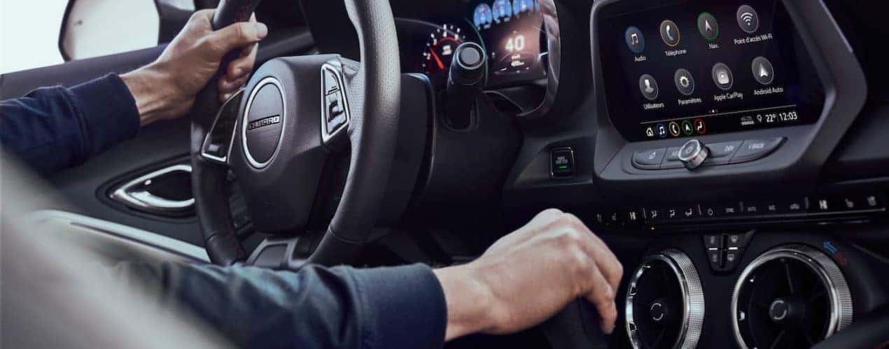 A close up shows a person shifting gears in a 2023 Chevy Camaro SS.