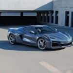 A grey 2024 Chevy Corvette E-Ray 3LZ is shown driving through a parking garage after looking at electric vehicles for sale.