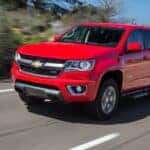 A red 2015 Chevy Colorado is shown from the front at an angle.