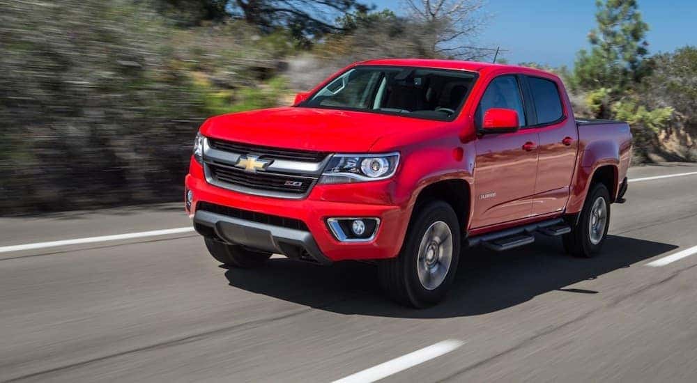 A red 2015 Chevy Colorado is shown from the front at an angle.
