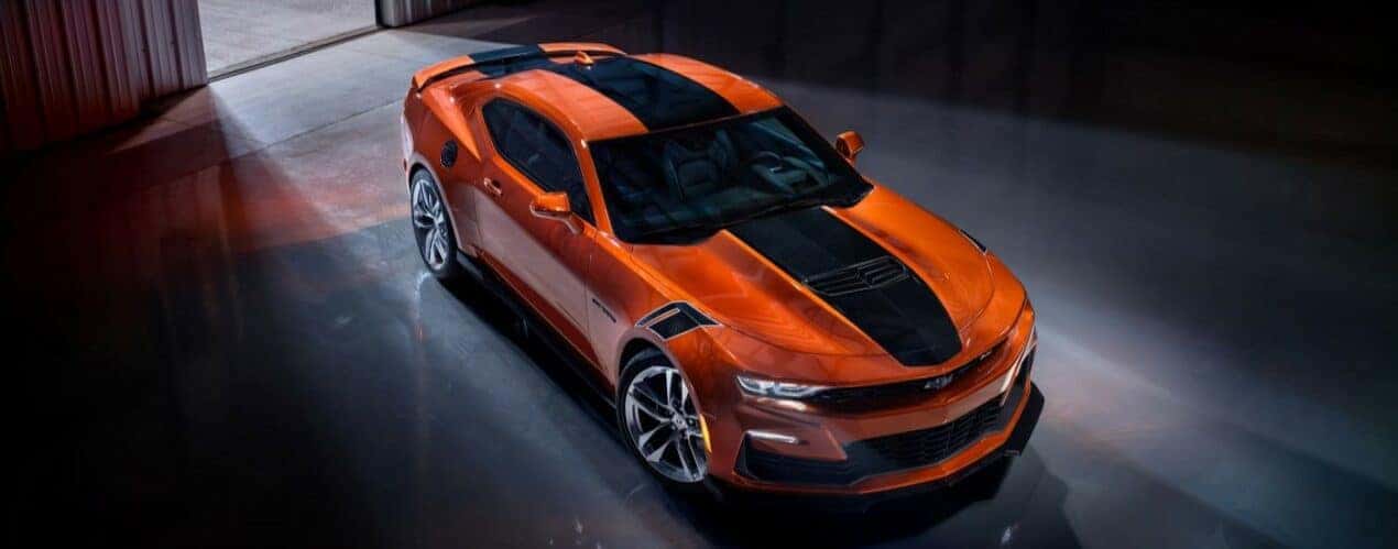 An orange 2023 Chevy Camaro SS is shown from a high angle.