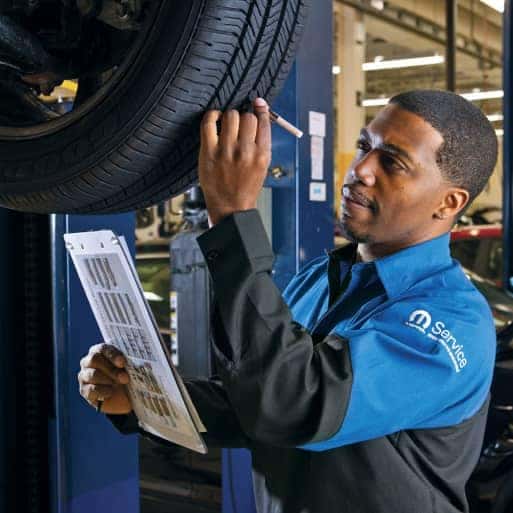 man servicing a car