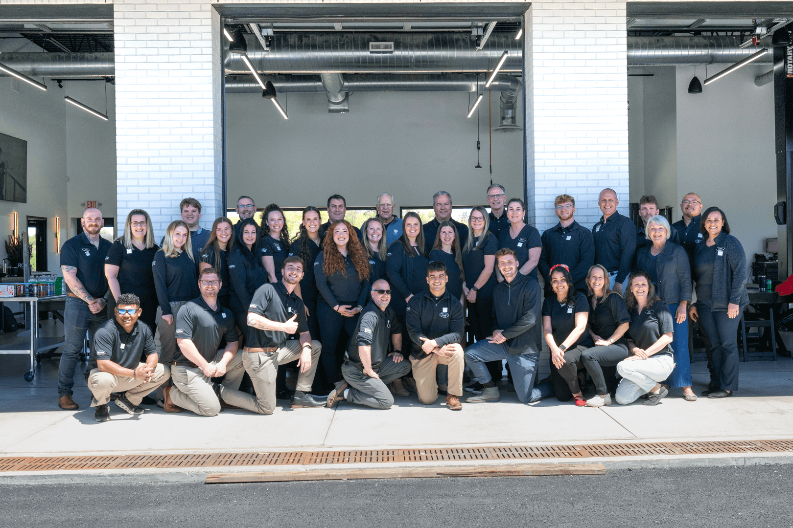 Royal-Buick-GMC-Staff-standing-outside-of-dealership-storefront