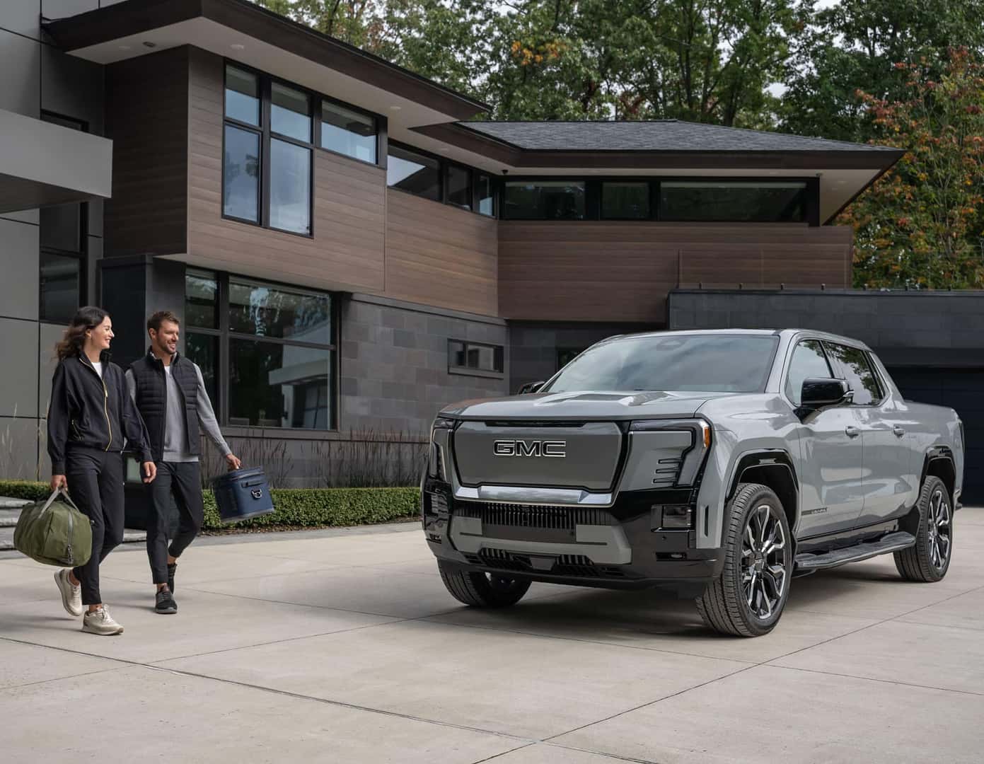 couple walking next to gmc truck