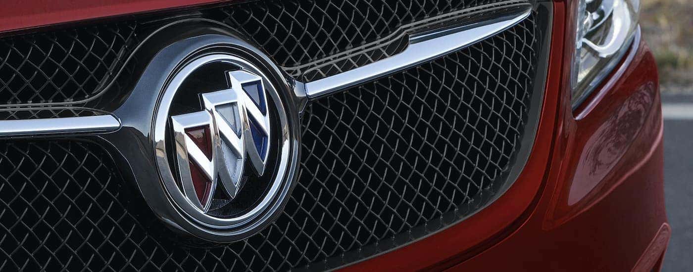 A close up shows the grille and badge on a red 2019 Buick LaCrosse Sport Touring.