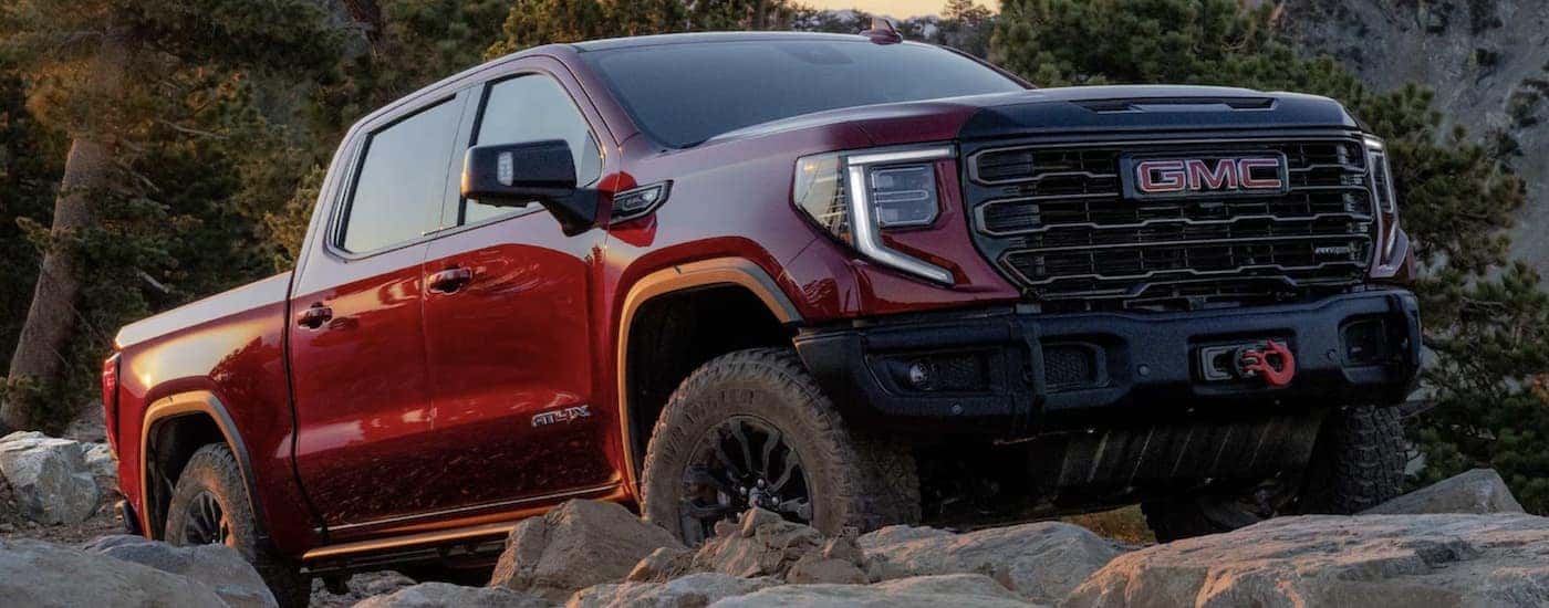 A red 2023 GMC Sierra 1500 AT4X is shown from the side after leaving a GMC Sierra 1500 dealer.