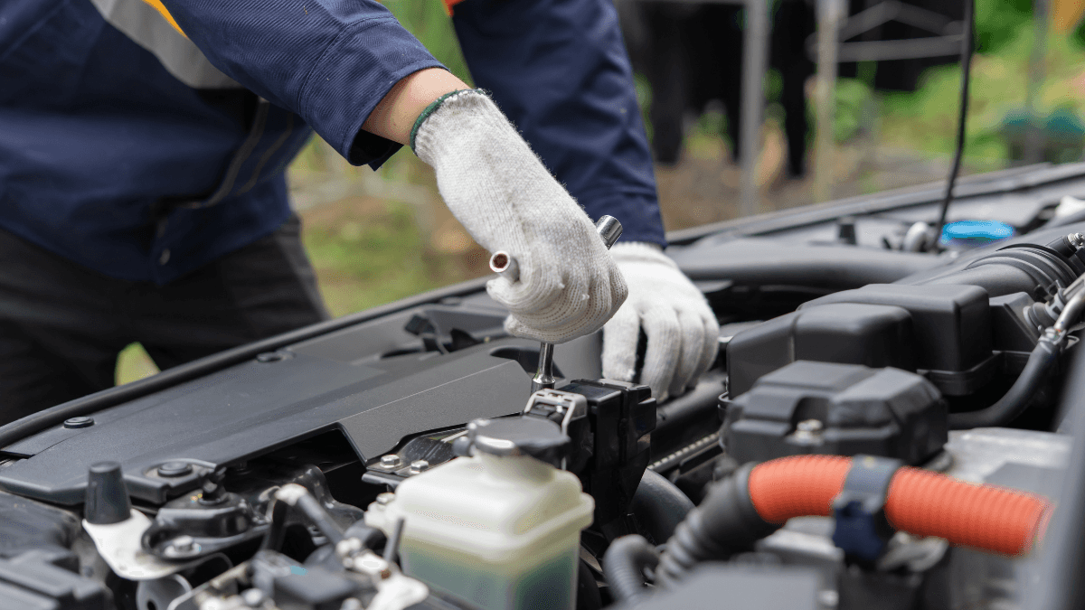 An engineer performing maintenance of a vehicle's engine