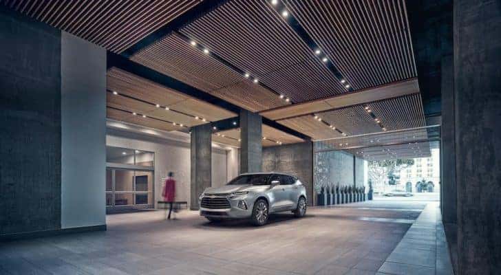A silver 2019 Chevy Blazer Premier is shown parked in front of a building.