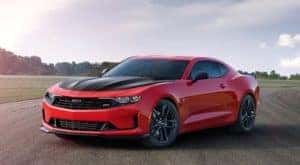 A red 2022 Chevy Camaro SS is shown from the front at an angle after leaving a Chevy Dealer