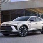 A white 2024 Chevy Blazer EV is shown from the front at an angle while parked in a driveway.