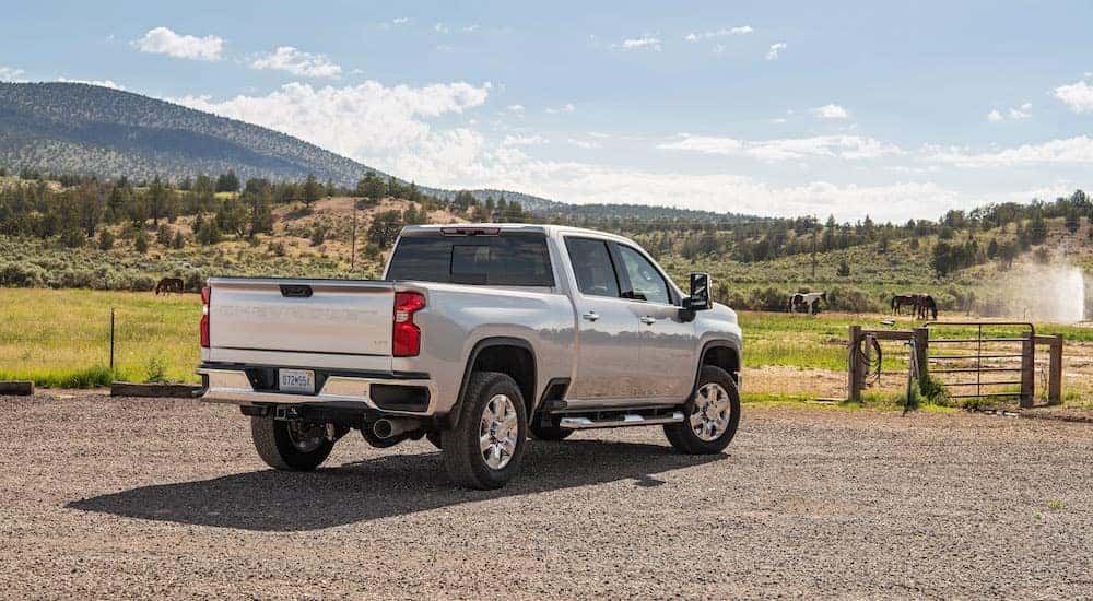 A silver 2022 Chevy Silverado 2500 HD is shown from the rear at an angle.