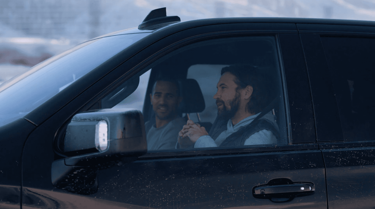 A driver utilizing Super Cruise technology next to a front-seat passenger