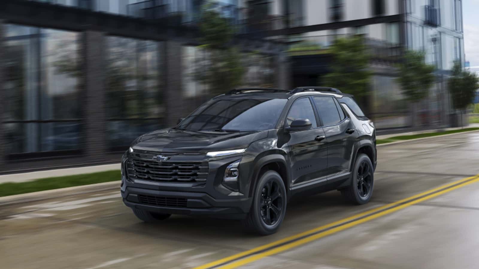A black Chevrolet Equinox driving down the street