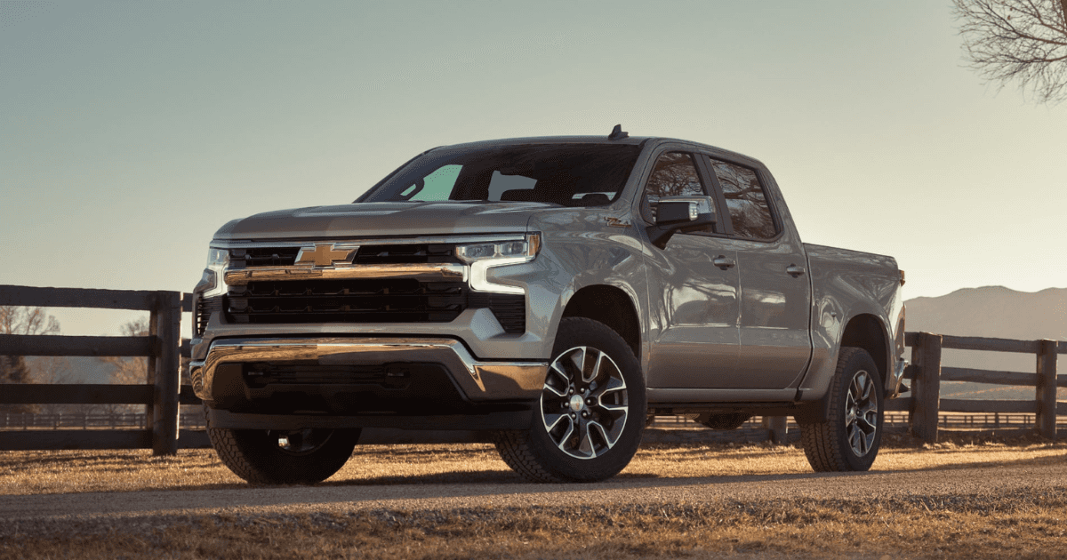A gray 2025 Chevrolet Silverado 1500 parked on a road on a ranch