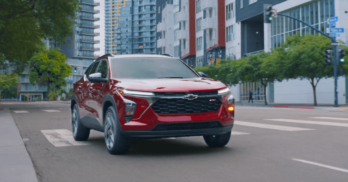 A red 2025 Chevrolet Trax driving down the road.