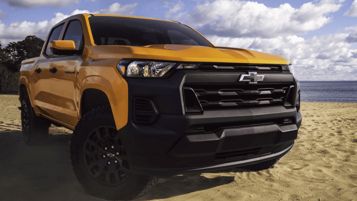 A yellow Chevy Colorado parked on a beach