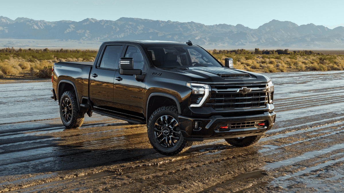 A black Chevy Silverado 2500 driving over muddy terrain.