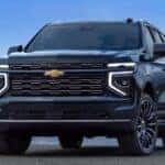 A blue Chevrolet Tahoe parked near a lake