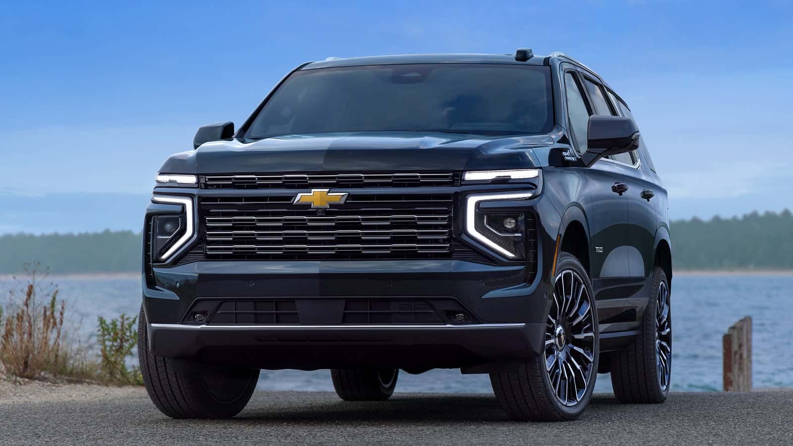 A blue Chevrolet Tahoe parked near a lake