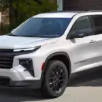 A white Chevrolet Traverse parked in a driveway