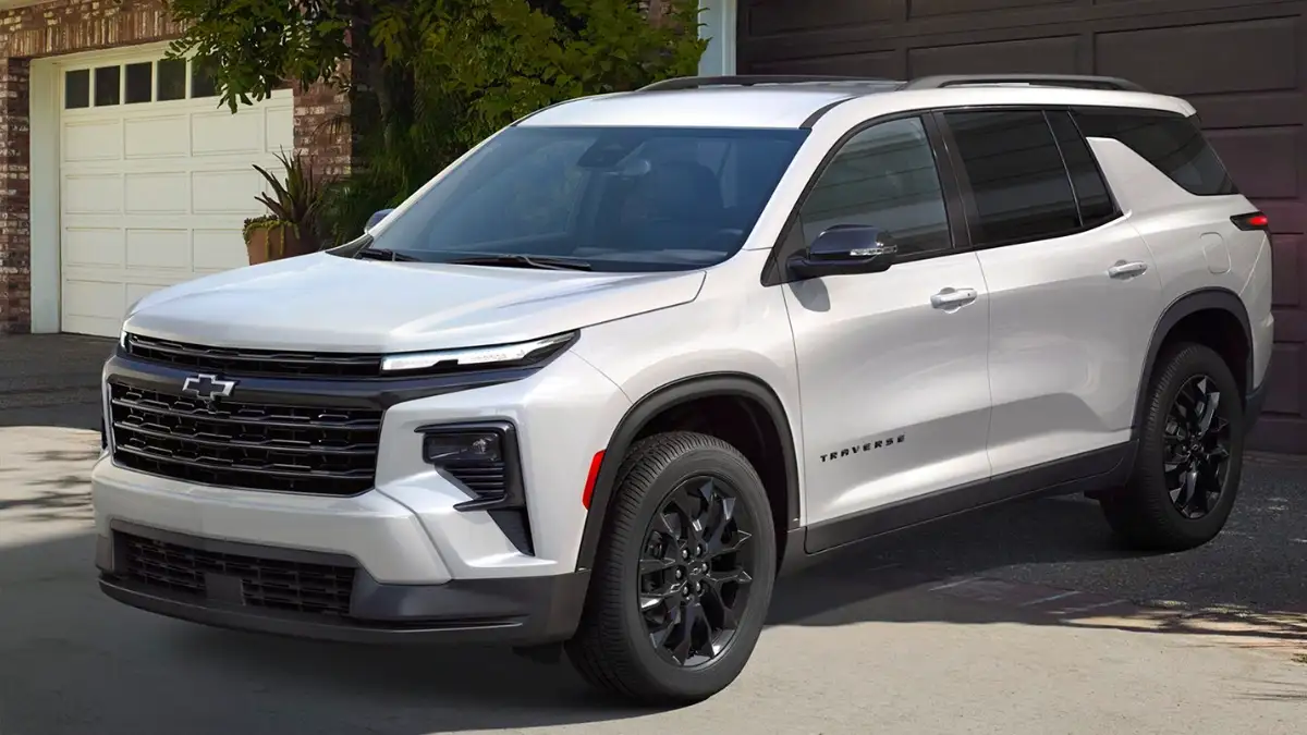 A white Chevrolet Traverse parked in a driveway