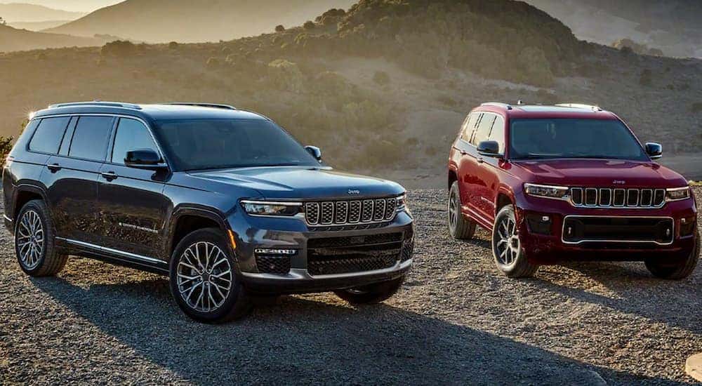 A grey and a red 2022 Jeep Grand Cherokee L are shown from the front.