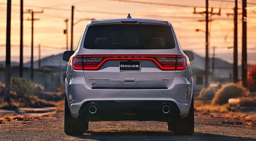 A silver 2022 Dodge Durango SRT is shown from behind at sunset.
