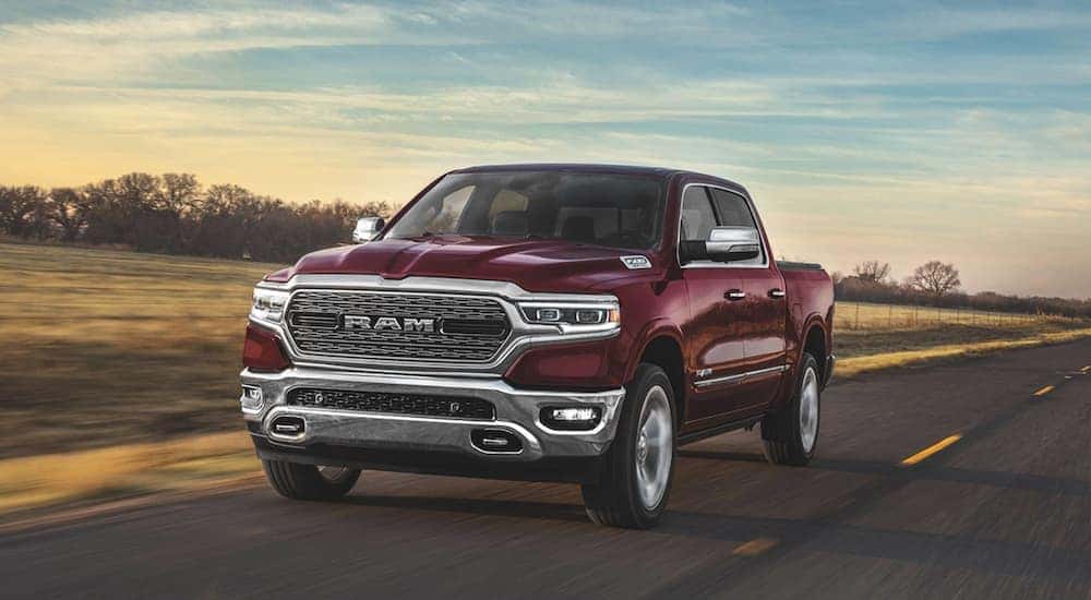 A maroon 2020 Ram 1500 Laramie is shown driving on an open road.