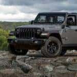 A gray 2022 Jeep Wrangler Willys is shown from the front at an angle.