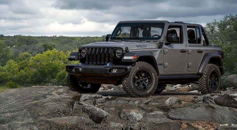 A gray 2022 Jeep Wrangler Willys is shown from the front at an angle.